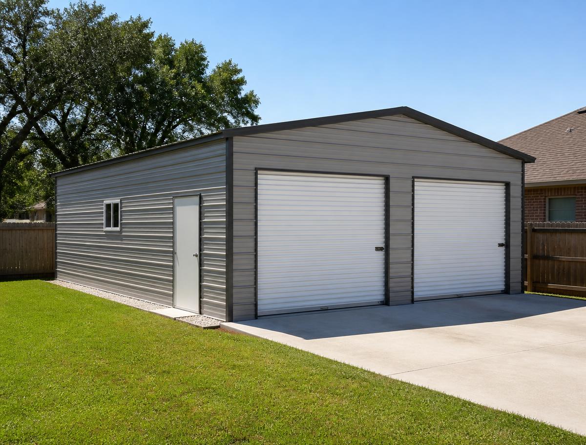 Two-car detached metal garage with white roll-up doors beside a Texas home
