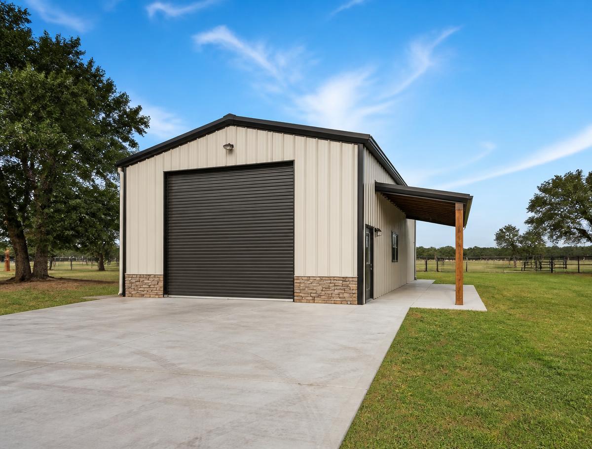 Residential metal workshop building with roll-up door and concrete apron